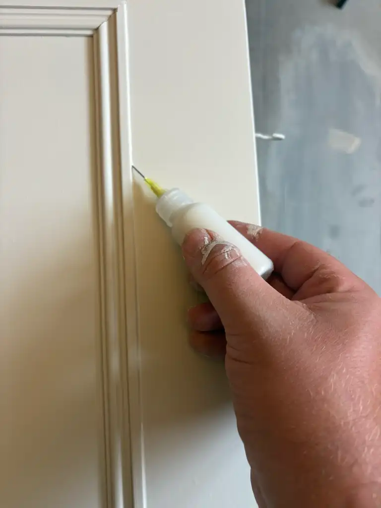 Panelling being carefully finished by Thomas Goodchild following spraying